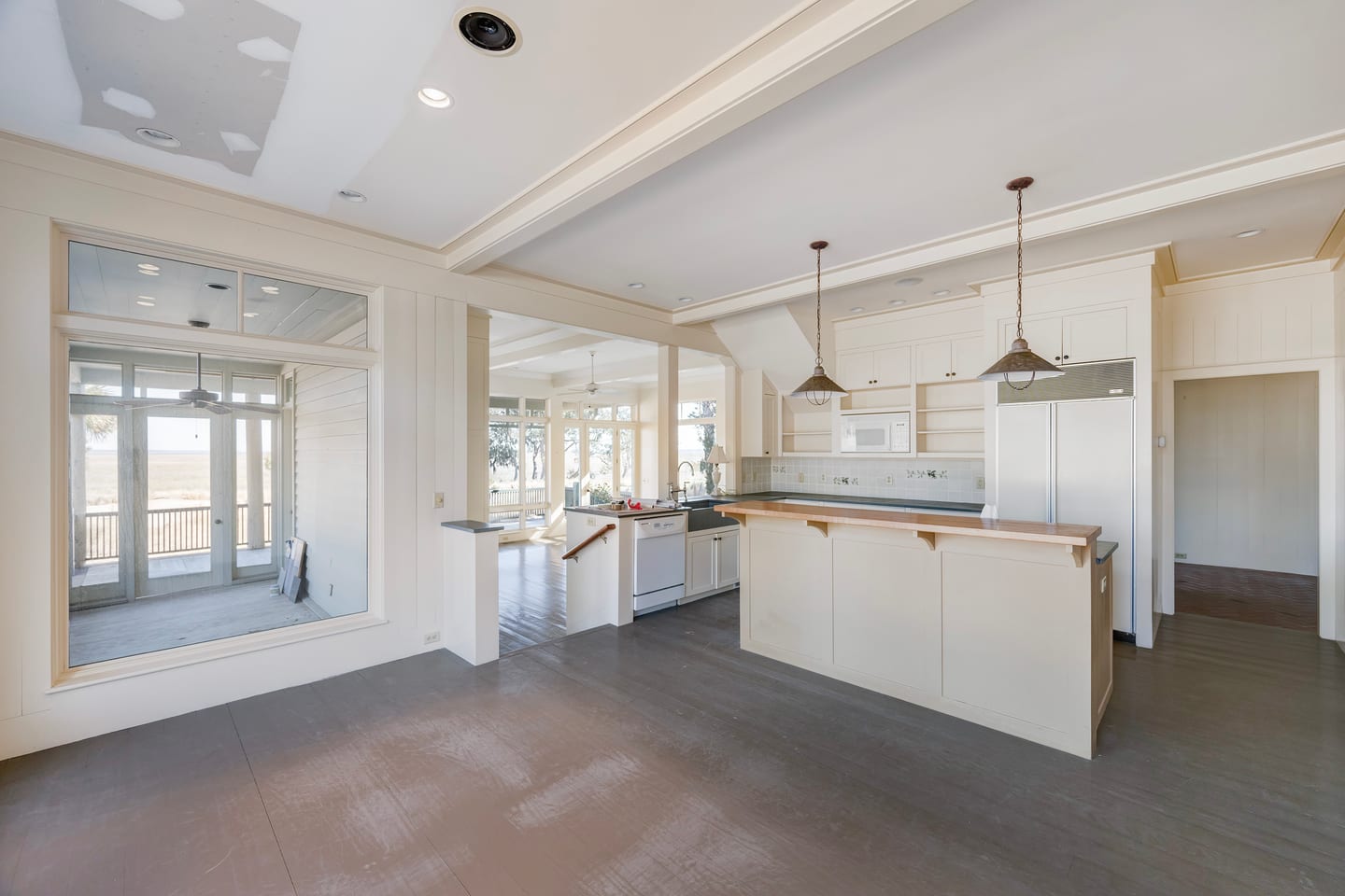 The original kitchen before renovation: island, perimeter cabinets and worn painted floors