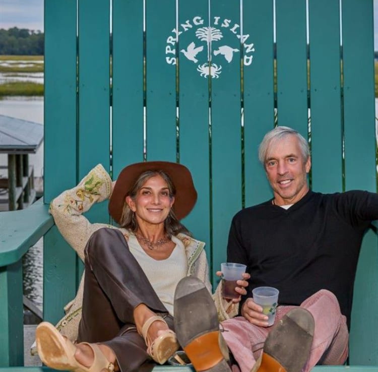 Lisa Furey and Jim Colton seated in painted Adirondack chairs on Spring Island